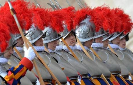 Swiss guards in their traditional uniforms watched Pope Francis.
